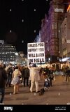 man-holding-repent-sign-in-leicester-square-london-uk-2AP47AK.jpg
