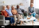 international-group-of-elderly-people-watching-tv-at-nursing-home-2HM4K2B.jpg