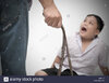 belt-in-father-hand-punish-son-because-he-do-not-do-homework-M5PNJP.jpg
