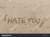 stock-photo-handwriting-words-i-hate-you-on-sand-of-beach-642453073.jpg